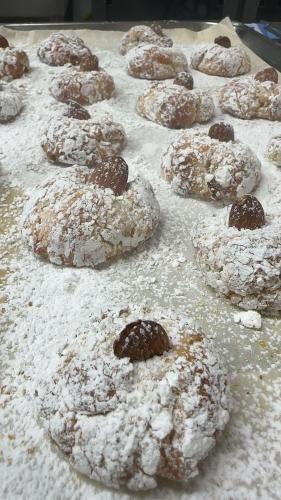 a bunch of donuts with powdered sugar on a table at Ines Apartments in Giardini Naxos