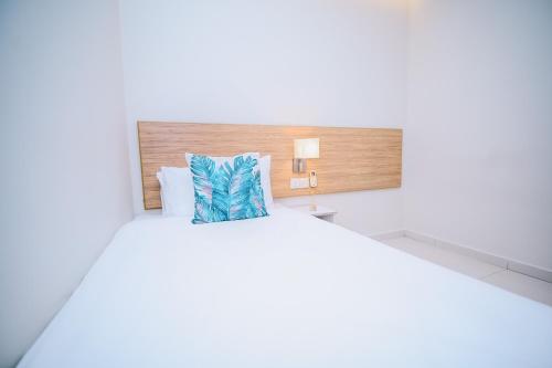 a bedroom with a bed with a pillow on it at Swing & Pillows - Kelana Jaya Selangor in Petaling Jaya