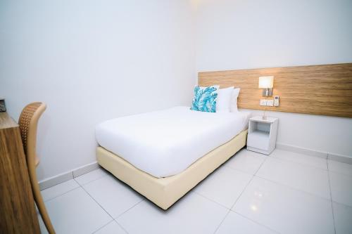 a bedroom with a large white bed in a room at Swing & Pillows - Kelana Jaya Selangor in Petaling Jaya