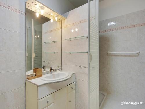 a bathroom with a sink and a glass shower at Quiet and bright studio - 2P - Rueil Malmaison in Rueil-Malmaison