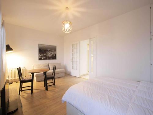 a bedroom with a bed and a table and chairs at Super apartment 2P Av Foch - Dauphine - MOBILITY LEASE in Paris