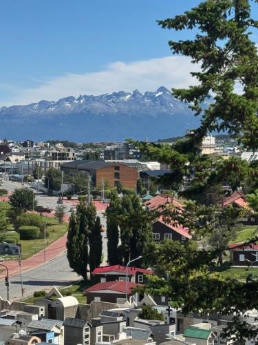 a city with snow capped mountains in the background at Edificio Libertador , Ushuaia in Ushuaia
