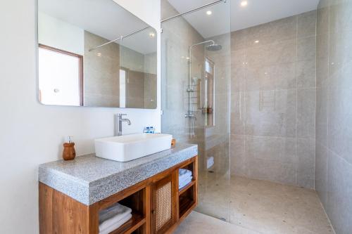 a bathroom with a sink and a shower at Akasia Hill Villas in Nusa Dua