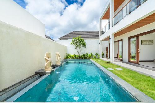 a swimming pool in the backyard of a house at Akasia Hill Villas in Nusa Dua