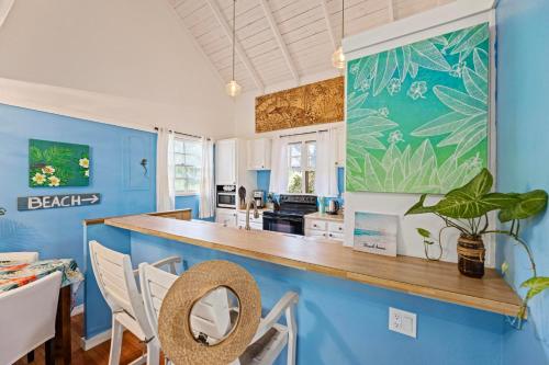 a kitchen with blue walls and a counter top at Beautiful Beachfront Townhouse 3bdrm 2bth with outside day bed OR overflow bedroom in Maunaloa