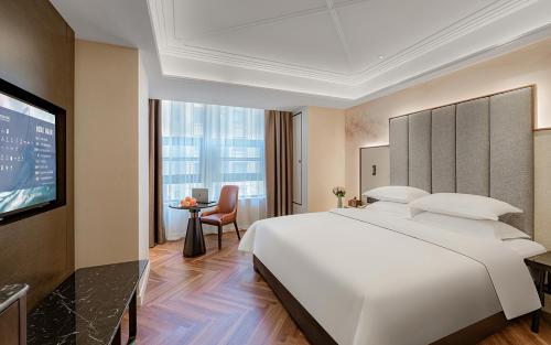 Letto o letti in una camera di Metropolo Hotel Xuzhou High-speed Railway Station Jinlonghu