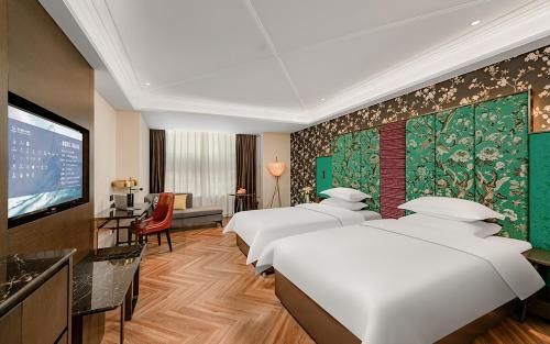 Letto o letti in una camera di Metropolo Hotel Xuzhou High-speed Railway Station Jinlonghu