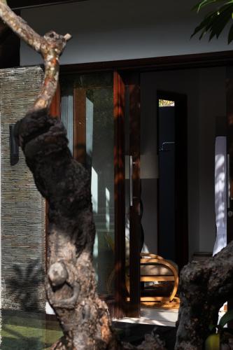 a statue of a tree in front of a house at Pondok Santi Estate in Gili Trawangan
