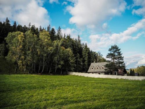 a house in the middle of a field with trees at Villa in Fren tát near Ski Resorts & Jacuzzi in Frenštát pod Radhoštěm