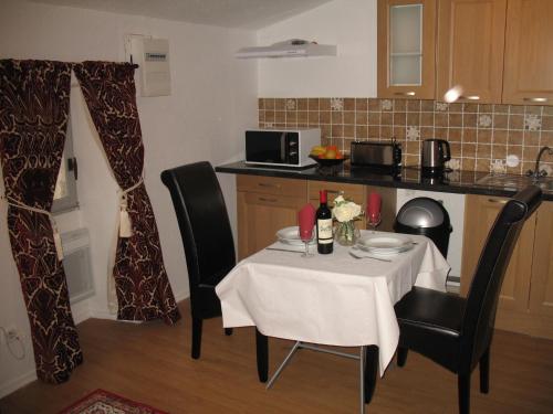 a kitchen with a table with a white table cloth at Domus Dulcis in Ribérac