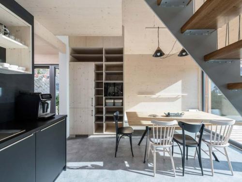a kitchen and dining room with a table and chairs at Villa in Bohemia with barbecue in Bedřichov