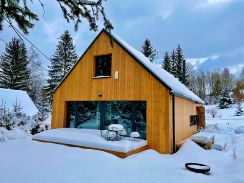 a wooden barn with snow on the ground at Villa in Bohemia with barbecue in Bedřichov