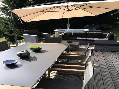 a table and chairs with an umbrella on a deck at Villa in Tanvald near Ski Slopes in Tanvald