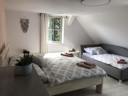 a bedroom with two beds and a table and a window at Villa in Tanvald near Ski Slopes in Tanvald