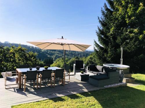 a patio with an umbrella and a table and chairs at Villa in Tanvald near Ski Slopes in Tanvald