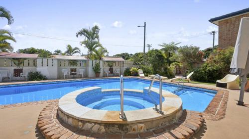 a large swimming pool in a yard at Ocean Parade 20 - Ocean Parade 20 - Resort access, BBQ, Surf Beach in Coffs Harbour
