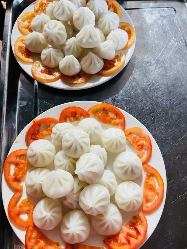 two plates of dumplings on plates on a table at Homestay Tommy House in Ha Giang
