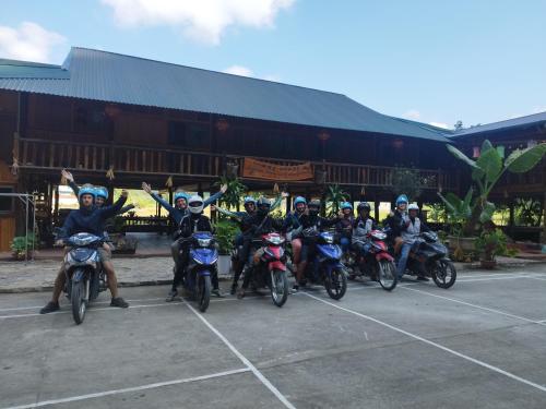 a group of people on motorcycles in front of a building at Homestay Tommy House in Ha Giang