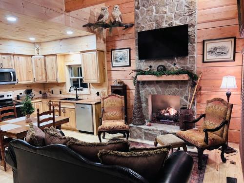 a living room with a fireplace and a television at Turkey Creek Cabin Rentals #2 at Tims Ford lake in Tullahoma
