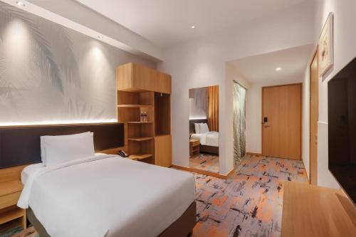 a hotel room with a bed and a bedroom at Holiday Inn Express Singapore Orchard Road by IHG in Singapore