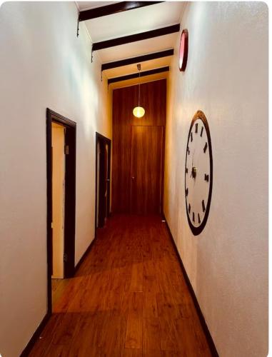 an empty hallway with a clock on the wall at Tiares Homestay in Suva