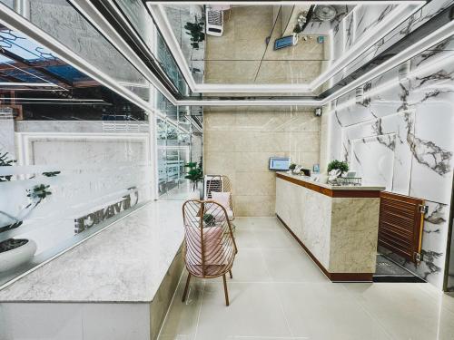 a lobby with a chair and a counter in a room at Ngoc San San Hotel HCM in Ho Chi Minh City