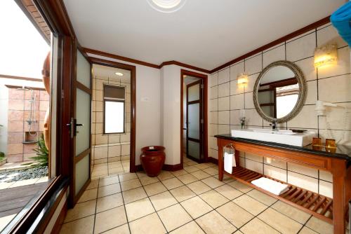 a bathroom with a sink and a mirror at Grand Lexis Port Dickson in Port Dickson