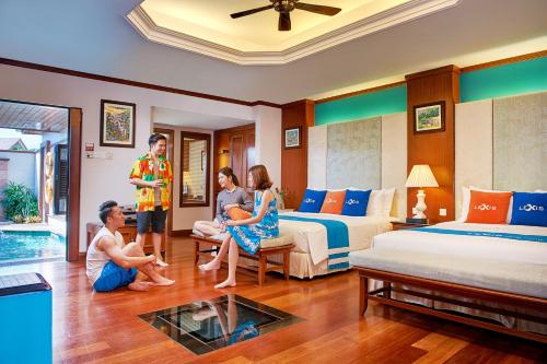 a group of people sitting in a hotel room at Grand Lexis Port Dickson in Port Dickson