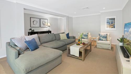 a living room with a couch and a table at Highlands on Alice in Bowral