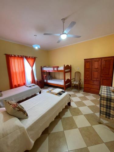 a bedroom with two beds and a table and a couch at Santa Martina in Merlo