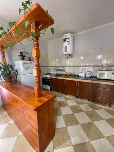 a kitchen with a wooden table in the middle at Santa Martina in Merlo