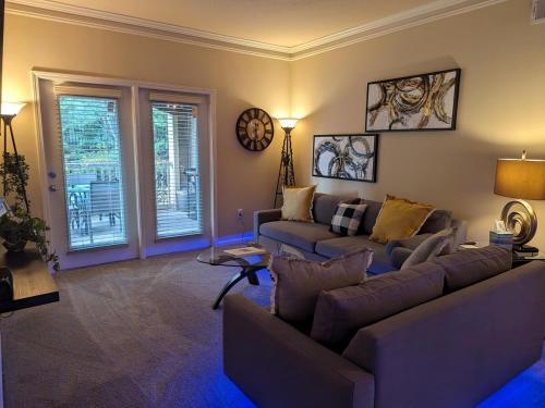 a living room with a couch and a table at Home away from Home - Book Friday and Saturday Get Sunday Free! Sleeps 7 Immediate Availability! Beautiful Gated Community in Charlotte