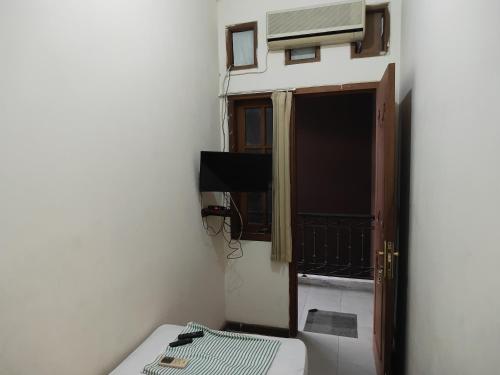 a small room with a bed and an open door at Tirto 27 homestay in Yogyakarta