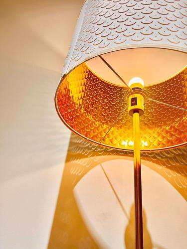 a lamp with a straw hat on a table at Legoland-8min walk at Kairos Comfort Spacious Suite for Families 1-12pax in Nusajaya