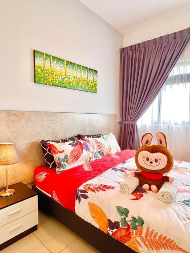 a bedroom with a bed with a stuffed monkey on it at Legoland-8min walk at Kairos Comfort Spacious Suite for Families 1-12pax in Nusajaya