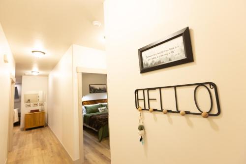 a hallway leading to a bedroom with a bed at Two Pines Retreat - Brand New! in Cedar City