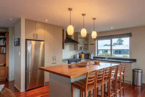 a kitchen with a wooden counter top and a refrigerator at Lake View Inn in Rotorua