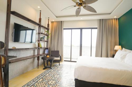 a hotel room with a bed and a window at The Interlude Art Retreat in Hoi An