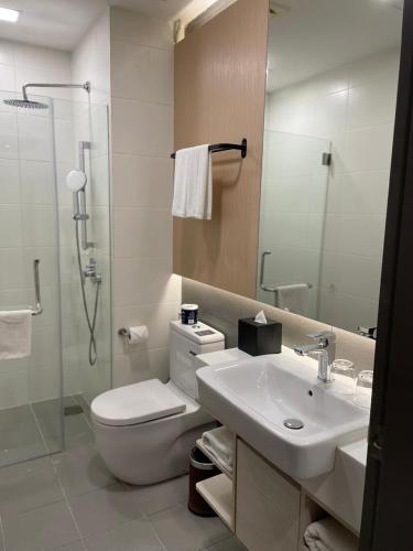 a bathroom with a toilet and a sink and a shower at Suasana Suites Johor Bahru City Centre in Johor Bahru