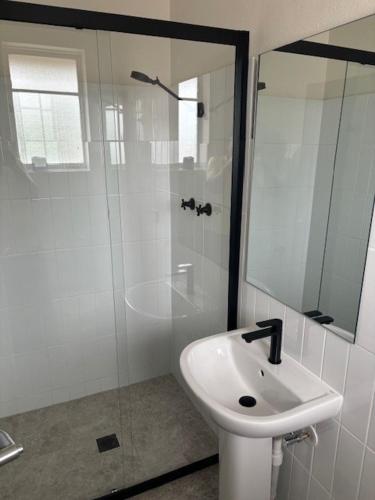 a bathroom with a sink and a glass shower at Riverwood Hotel - Adults Only in Riverwood