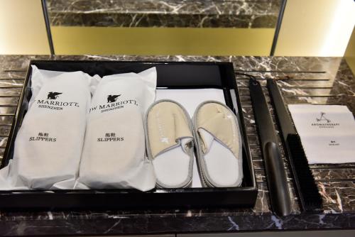 a box with a pair of shoes and a pair of socks at JW Marriott Hotel Shenzhen Bao'an International Airport in Bao'an