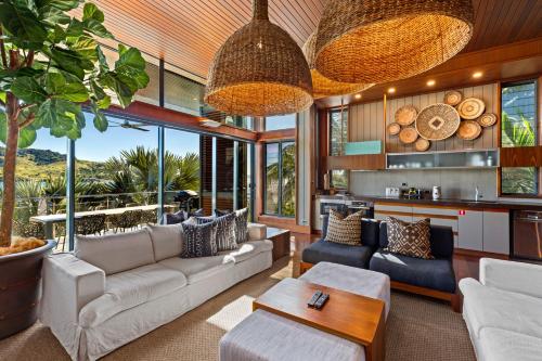 a living room with a couch and a table at Yacht Club Villas on Hamilton Island by HIHA in Hamilton Island