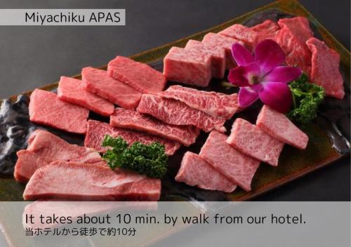 a plate of meat with a purple flower on it at K's Street Hotel Miyazaki in Miyazaki