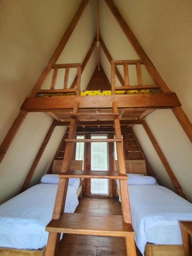 a room with two beds in a attic at Villa Lumbung Salak in Bogor