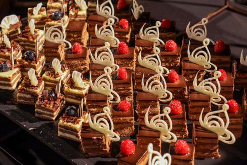 a bunch of desserts sitting on a table at Centara Mirage Resort Mui Ne in Mui Ne