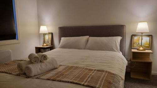 a bedroom with a bed with a towel on it at Camellia Grove Retreat in Mount Macedon