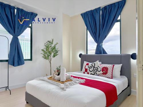 a bedroom with a large bed with blue curtains at Costa Mahkota - 1min I Mahkota Parade Mall I Dataran Pahlawan I Mahkota Hospital in Melaka