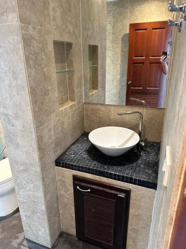 a bathroom with a white sink on a counter at Baan Chaweng Hill poolside Samui in Amphoe Koh Samui