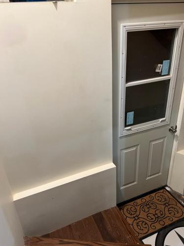 a room with a door and a window and a floor at Stylish City Escape in Toronto