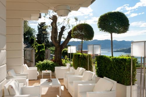 a patio with white furniture and a view of the ocean at Europa Grand Hotel in Lerici